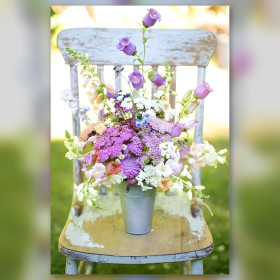 Lena diamond painting on chair with purple and white flower bouquet