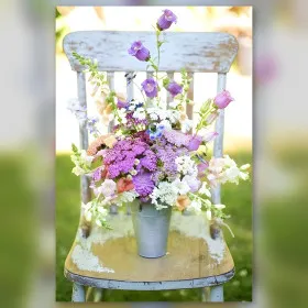 Diamond painting Lena sur chaise avec bouquet de fleurs violettes et blanches