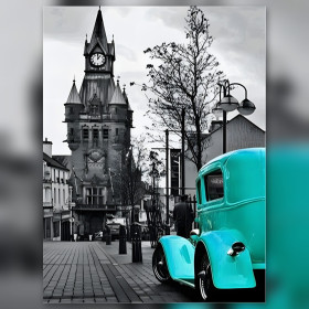 Auto vintage turchese su strada acciottolata con torre dell'orologio in diamond painting strass lucenti