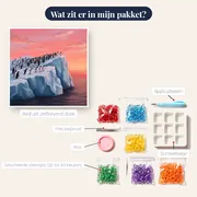 Pinguïnkolonie op ijsberg onder roze lucht – inhoud van het pakket